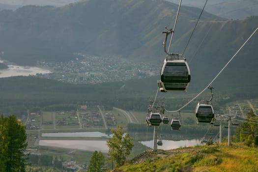 High angle shot of cableway on a cityscape and landscape background