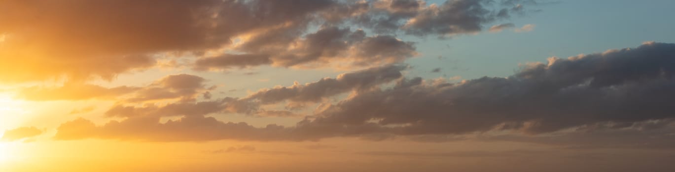 Amazing panoramic cloudscape at sunset in La Manche. Beautiful warm orange clouds.