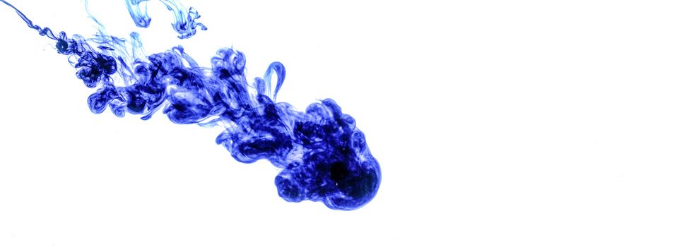 Blue ink injected into water from syringe, colour mixing with water creating abstract shapes, banner with space for text right side.