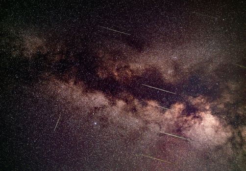 Meteor shower over Milky Way in region of Aquila constellation - long exposure photo.