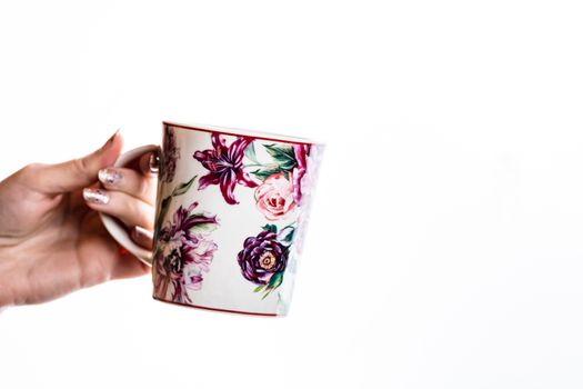 Woman hand holding a cup isolated on white background.