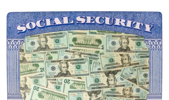 Concept of social security and retirement funding issues in USA with many US dollars laid out in inside the framework of a social security card