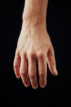 male hand, isolated on black