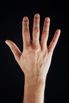 male hand, isolated on black