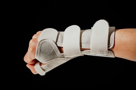 wrist and hand orthotics support for carpal tunnel syndrome healing, isolated on black