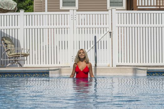 A gorgeous young blonde model poses in a bikini while enjoying a summers day