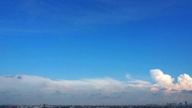 Blue sky and white clouds over the city in good weather summer day.