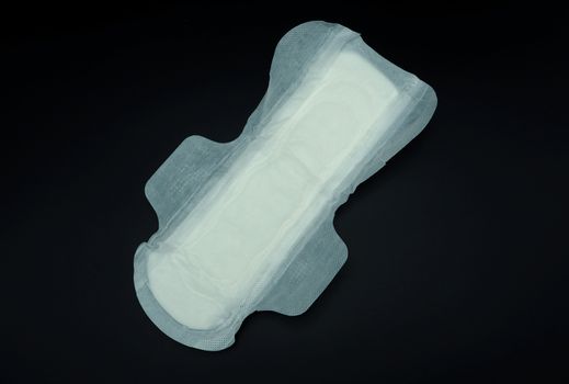 White color cotton sanitary pad for woman and black background.