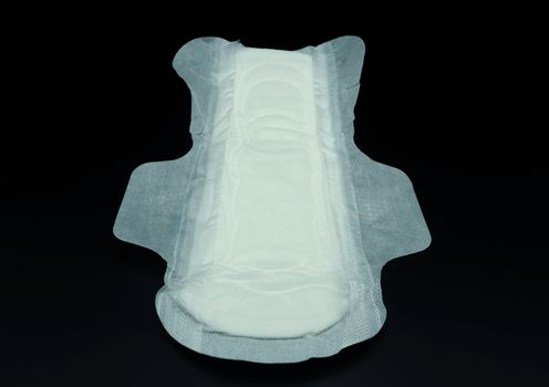 White color cotton sanitary pad for woman and black background.