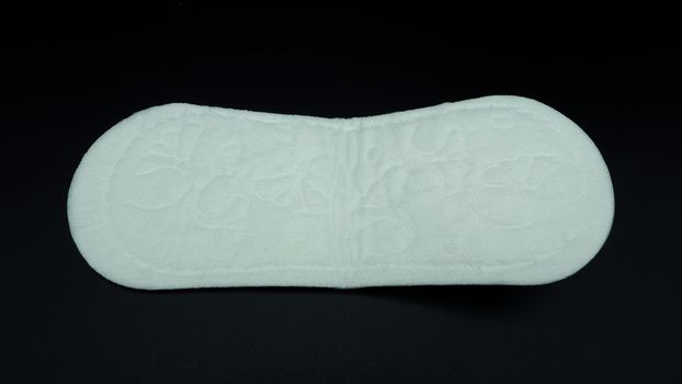 White color cotton sanitary pad for woman and black background.