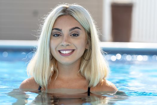 A gorgeous young blonde model poses in a bikini while enjoying a summers day