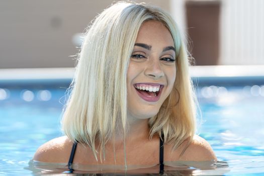 A gorgeous young blonde model poses in a bikini while enjoying a summers day
