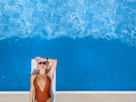 A gorgeous young blonde model poses in a bikini while enjoying a summers daydefault