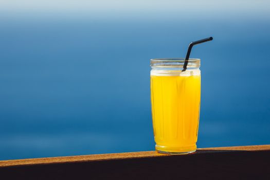 orange juice against blue sea background