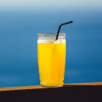 orange juice against blue sea background