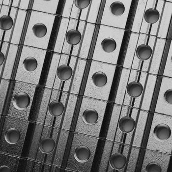 slide screw nuts in a row, abstract industrial background