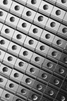 slide screw nuts in a row, abstract industrial background