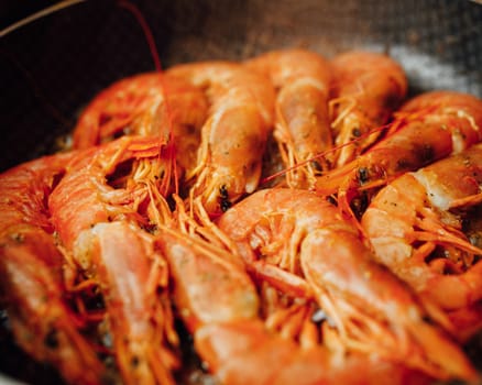 fried red shrimps with hot oil on pan