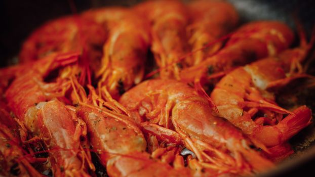 fried red shrimps with hot oil on pan