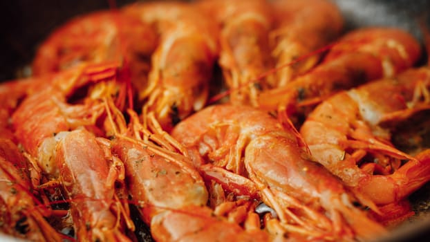 fried red shrimps with hot oil on pan