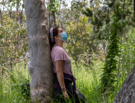 Real woman in the middle of the forest. face mask