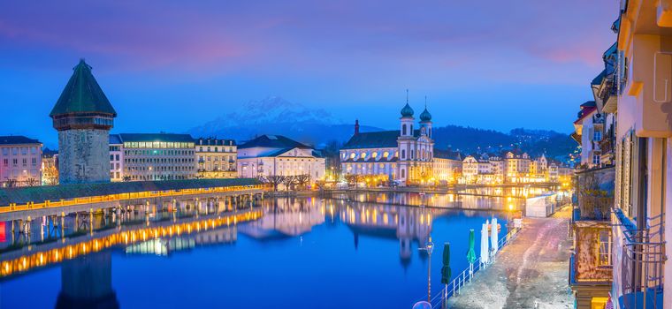 Historic city center of downtown Lucerne with  Chapel Bridge and lake Lucerne in Switzerland at sunset