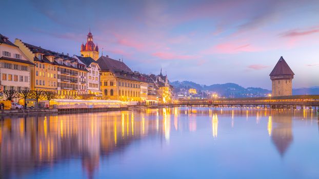 Historic city center of downtown Lucerne with  Chapel Bridge and lake Lucerne in Switzerland at sunset