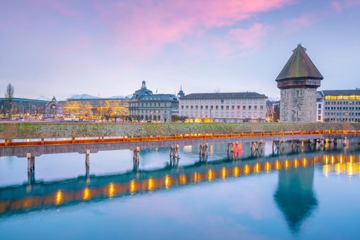 Historic city center of downtown Lucerne with  Chapel Bridge and lake Lucerne in Switzerland at sunset