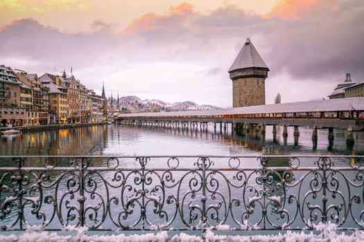 Historic city center of downtown Lucerne with  Chapel Bridge and lake Lucerne in Switzerland at sunset