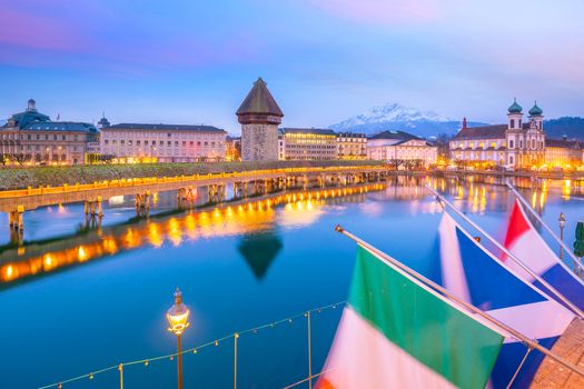 Historic city center of downtown Lucerne with  Chapel Bridge and lake Lucerne in Switzerland at sunset