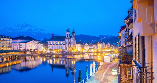 Historic city center of downtown Lucerne with  Chapel Bridge and lake Lucerne in Switzerland at sunset