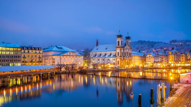 Historic city center of downtown Lucerne with  Chapel Bridge and lake Lucerne in Switzerland at sunset