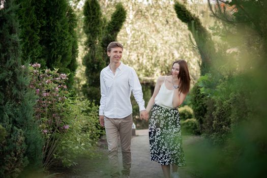 The young couple walking in the park