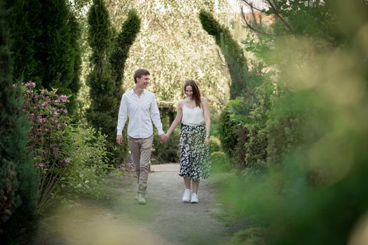 The young couple walking in the park