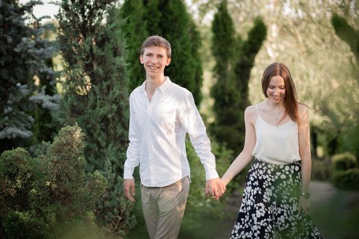 The young couple walking in the park