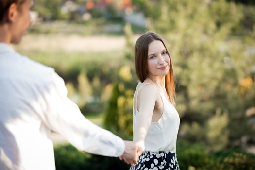 The young couple walking in the park