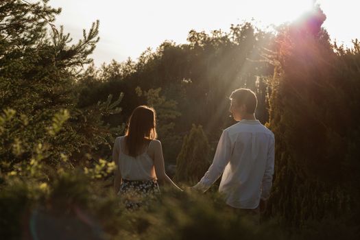 The young couple walking in the park