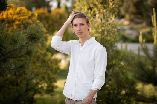 Young blonde man. Man outside. Outside on nature