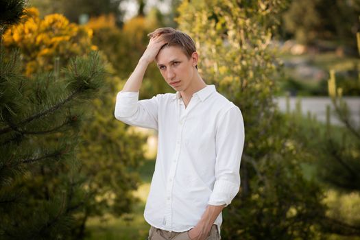 Young blonde man. Man outside. Outside on nature