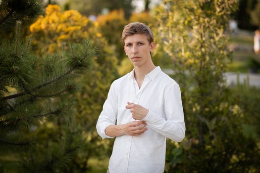 Young blonde man. Man outside. Outside on nature