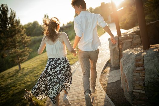 The young couple walking in the park