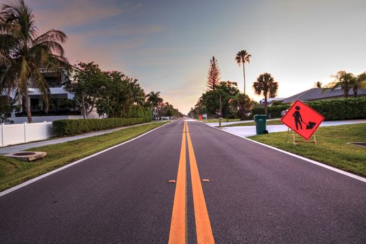 Construction sign on the side of Vanderbilt Drive in Naples Park, Naples, Florida at sunrise.