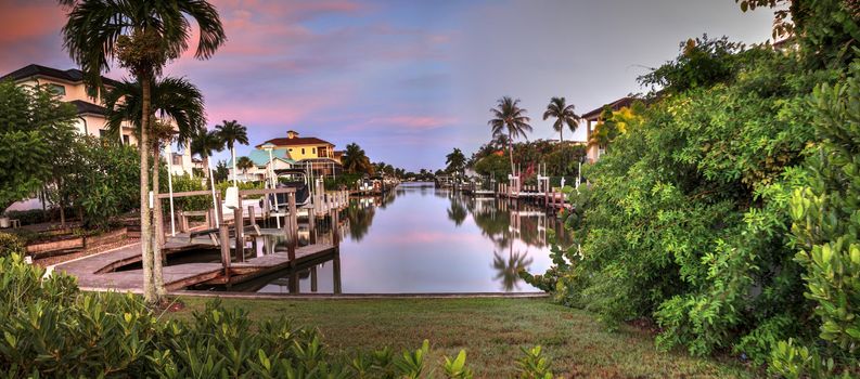 Sunrise over a Waterway leading to the Ocean near Vanderbilt Beach in Naples, Florida.