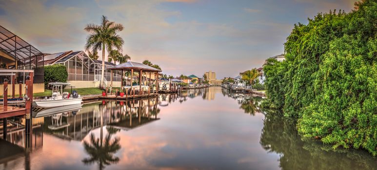 Sunrise over a Waterway leading to the Ocean near Vanderbilt Beach in Naples, Florida.