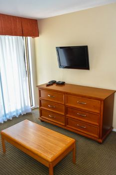 Corner of the living room with furniture and TV screen on the wall