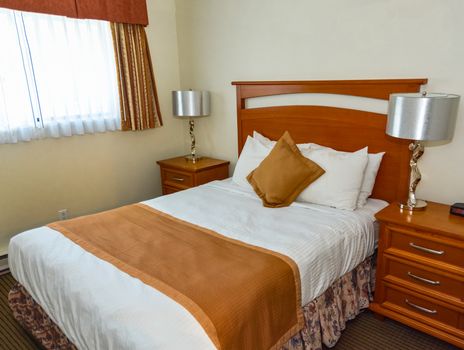Double bed in the bedroom with the lamp on bedside tables