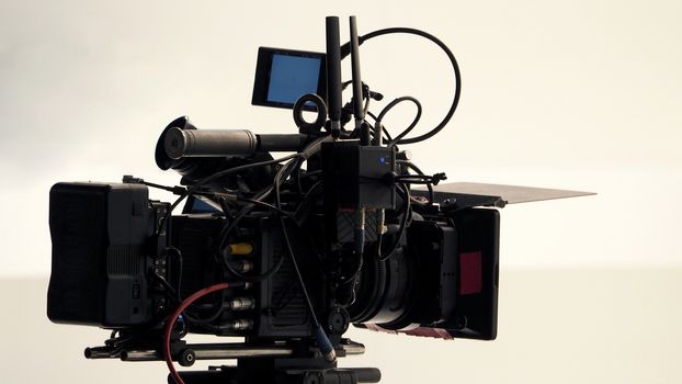 4K high defination video camera with tripod shooting in studio production and no people.