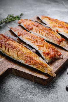 Fish fillet marinated with paprika and saffron on grey background.