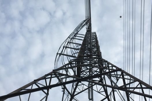 Close up view , high voltage power lines station. High voltage electric transmission pylon silhouetted tower.