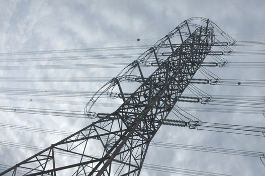 Close up view , high voltage power lines station. High voltage electric transmission pylon silhouetted tower.